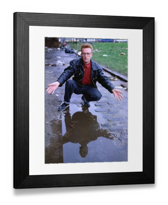 Framed Print : TV presenter Bryan Burnett kneeling next to puddle 1990 Framed Print : TV presenter Bryan Burnett kneeling next to puddle 1990