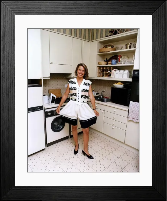 Framed Print : Anna Walker TV Presenter standing in kitchen holding out the legs of her shorts Framed Print : Anna Walker TV Presenter standing in kitchen holding out the legs of her shorts