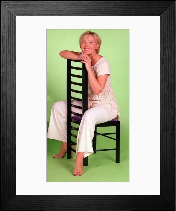 Framed Print : Kirsty Young TV Presenter Channel 5 sitting on chair wearing white trousers Framed Print : Kirsty Young TV Presenter Channel 5 sitting on chair wearing white trousers