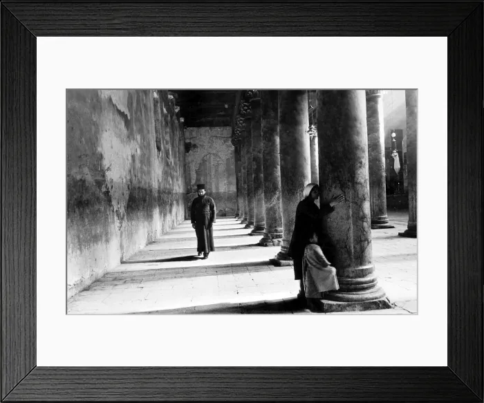 Framed Print : A Pilgrim Widow and child kisses the pillars on entering the church of Nativity in