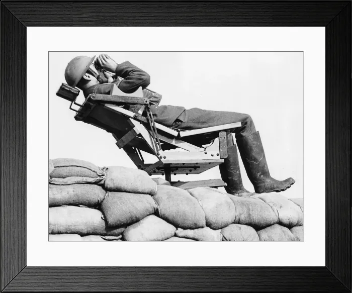 Framed Print : An aircraft observer lies back in a chair on top of a sand bag enforcement scanning Framed Print : An aircraft observer lies back in a chair on top of a sand bag enforcement scanning