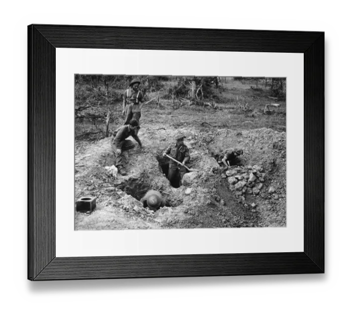  : British soldiers dig defences at the village of Hottot near Tilly Surseulles. WW2 1944