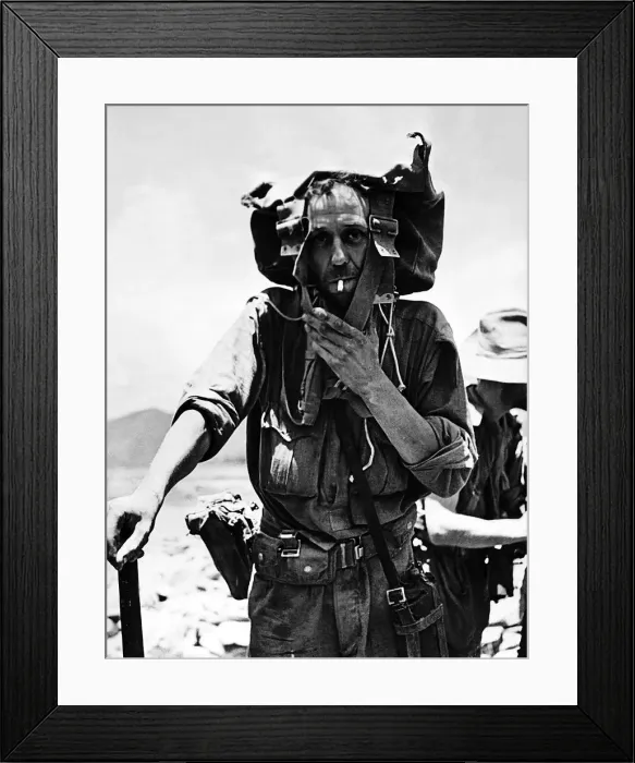 Framed Print : A British soldier uses his backpack to shade his head from the sun as he returns to India Framed Print : A British soldier uses his backpack to shade his head from the sun as he returns to India