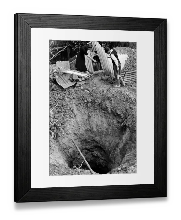 Framed Print : Bomb crater beside a garden shelter after an air raid on London 1940 WW2 Framed Print : Bomb crater beside a garden shelter after an air raid on London 1940 WW2