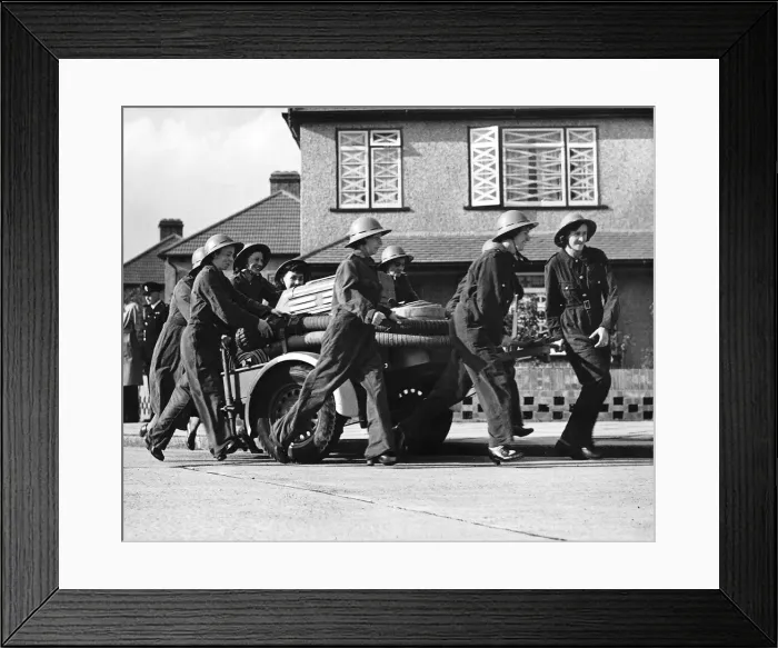 Framed Print : Women fire fighters from Erith Kent walk beside their trailer pump during WW2 1942