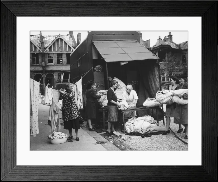 Framed Print : A mobile laundry service working from the back of a lorry accepts more washing during WW2 Framed Print : A mobile laundry service working from the back of a lorry accepts more washing during WW2