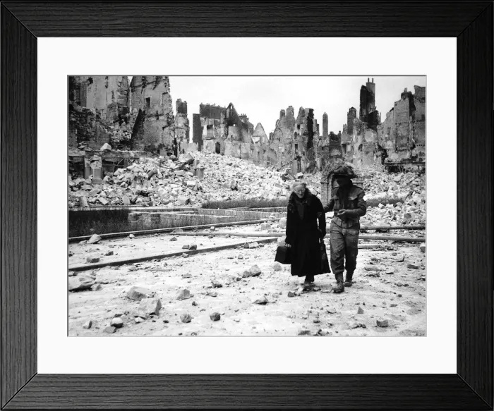 Framed Print : WW2 Invasion of Caen in France A soldier helps an elderly woman through