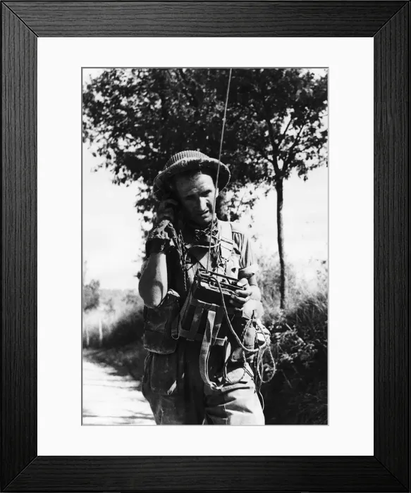 Framed Print : British signalman operating his No. 38 set as he walks along a road during WW2 Framed Print : British signalman operating his No. 38 set as he walks along a road during WW2