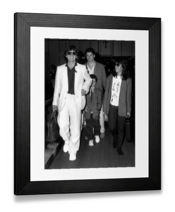 Framed Print : Former Beatles singer and guitarist George Harrison and family with a child of a friend Framed Print : Former Beatles singer and guitarist George Harrison and family with a child of a friend