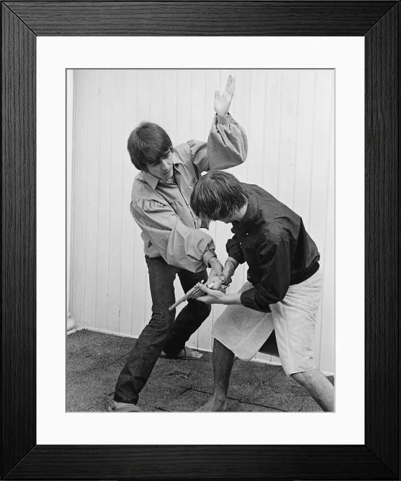 Framed Print : Beatles members George Harrison and Ringo Starr engage stage mock combat at the rented Framed Print : Beatles members George Harrison and Ringo Starr engage stage mock combat at the rented