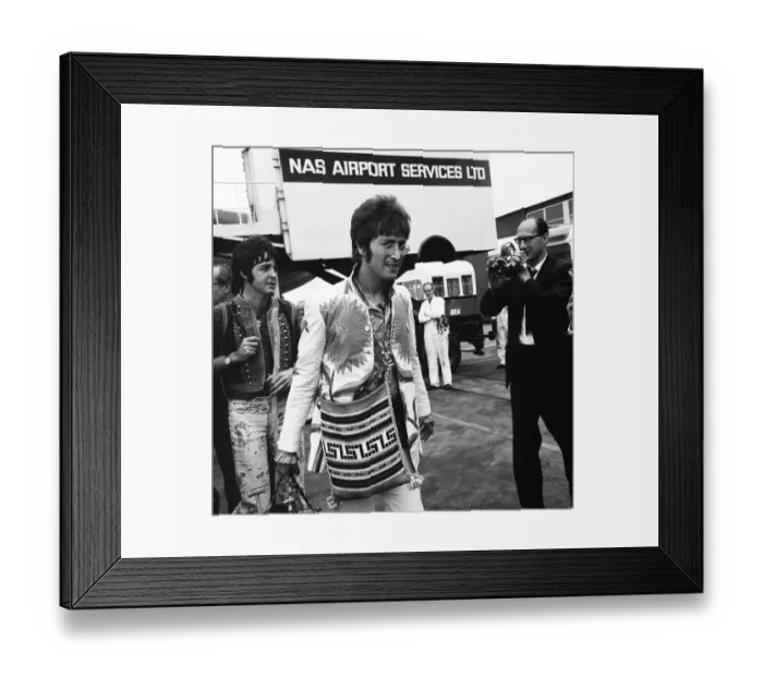 Framed Print : John Lennon and Paul McCartney arriving at Heathrow Airport from their Greek Holiday