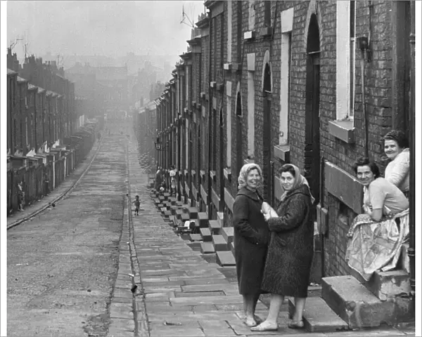 Liverpool housewives seen here gossiping in the street. Women holding parcel