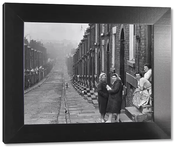 Liverpool housewives seen here gossiping in the street. Women holding parcel