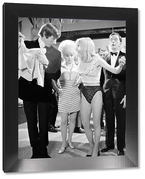 Jim Dale rips the skirt off Elizabeth Knight at a party attended by Barbara Windsor