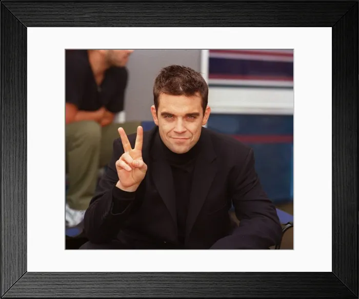 Framed Print : Robbie Williams relaxes on the set of his lastest video being shot in the grounds of Framed Print : Robbie Williams relaxes on the set of his lastest video being shot in the grounds of