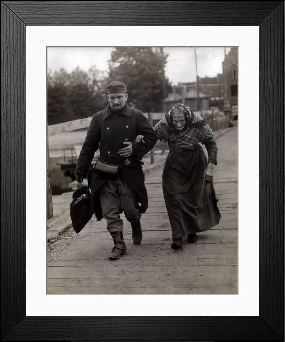 Framed Print : Belgian Soldier helps an aged woman refugee. August 1915 Framed Print : Belgian Soldier helps an aged woman refugee. August 1915