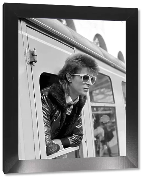 David Bowie leaning out of a railway carriage of the Paris boat train at Victoria station