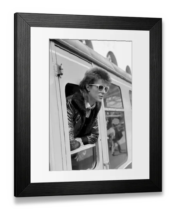Framed Print : David Bowie leaning out of a railway carriage of the Paris boat train at Victoria station Framed Print : David Bowie leaning out of a railway carriage of the Paris boat train at Victoria station