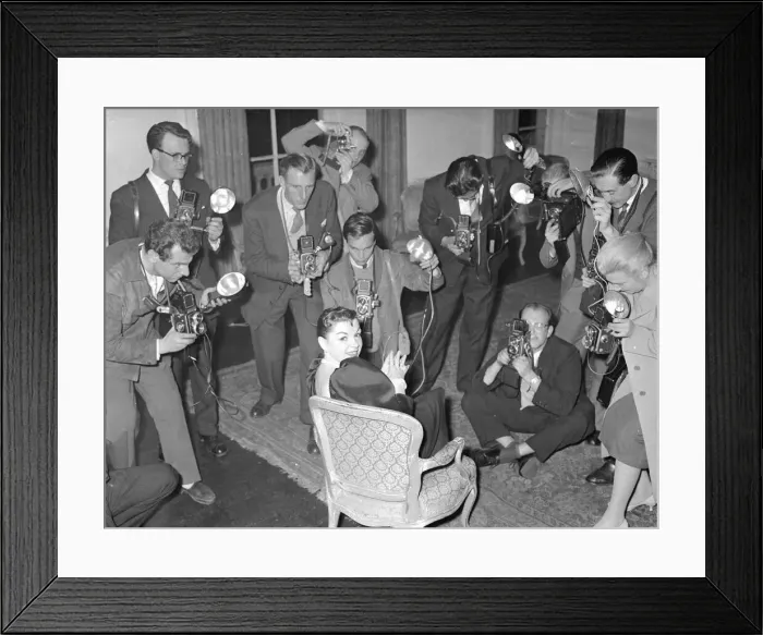 Framed Print : Actress Judy Garland at a press conference surronded by photographers taking