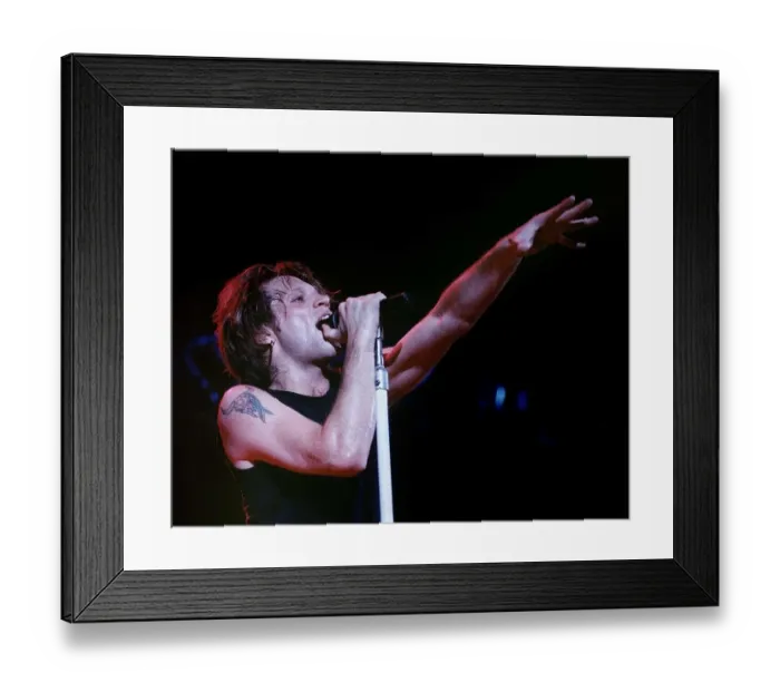Framed Print : Jon Bon Jovi lead singer of rock group Bon Jovi raises his hand to the audience while