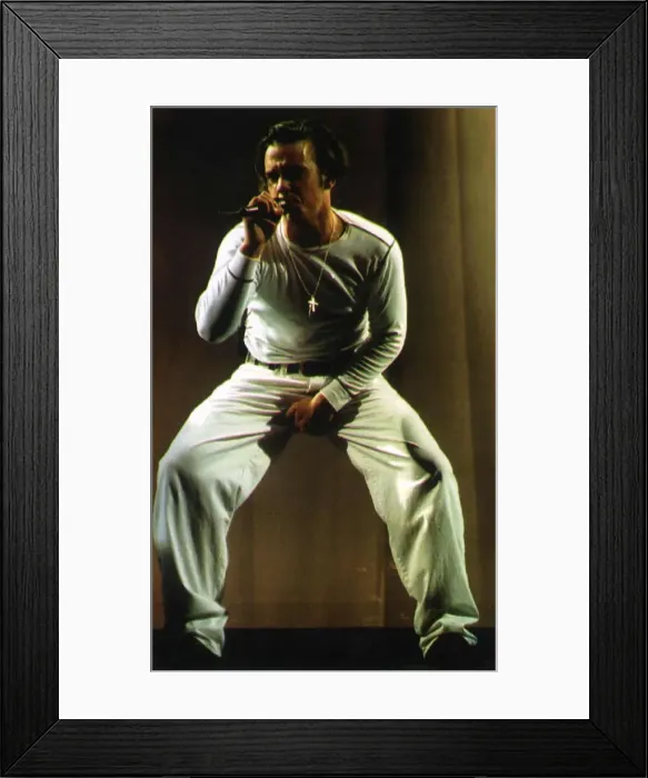 Framed Print : Robbie Williams of Pop Group Take That on stage during a concert in Manchester Framed Print : Robbie Williams of Pop Group Take That on stage during a concert in Manchester