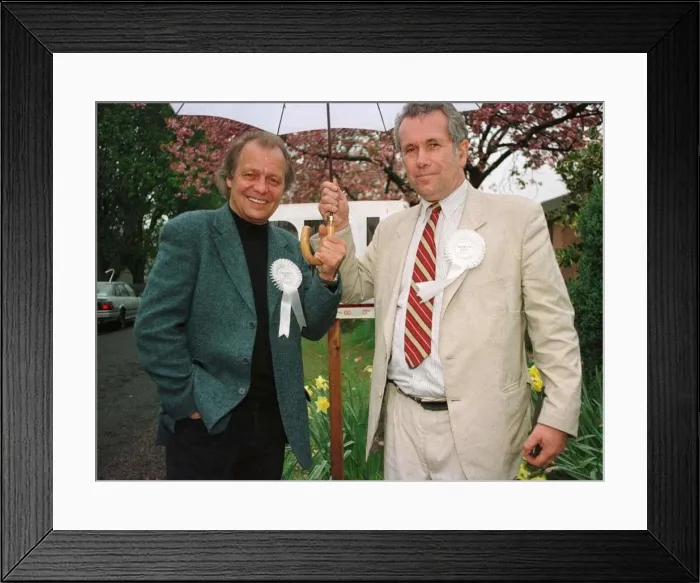 Framed Print : Martin Bell shares umbrella with actor David Sole during his election campaign April Framed Print : Martin Bell shares umbrella with actor David Sole during his election campaign April
