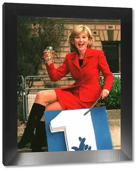 Anthea Turner TV Presenter celebrates 1 year of the National Lottery with a cake