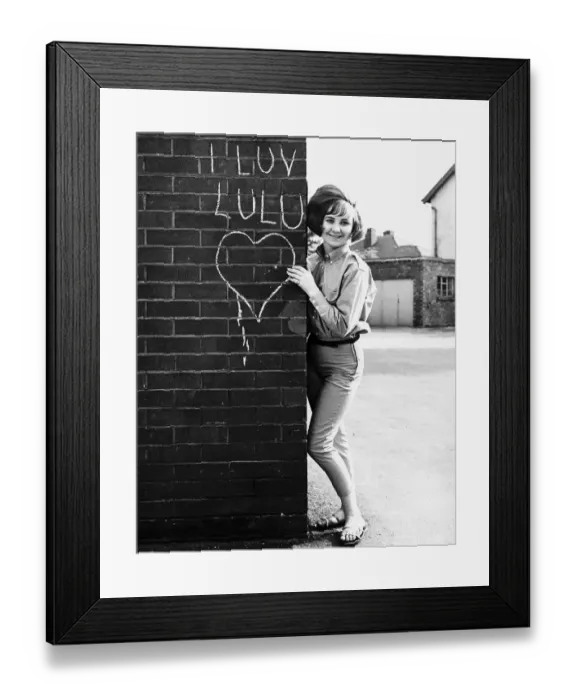 Framed Print : LuLu pop singer stands besides wall. 16th May 1964