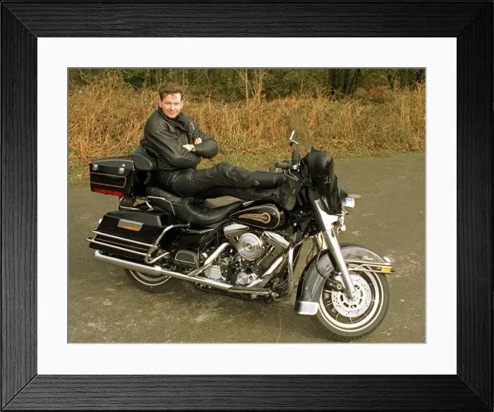 Framed Print : John Gordon Sinclair actor with his feet up on his Harley Davidson Electra Glide