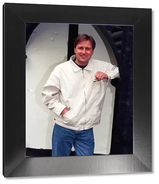 Gary Webster actor leaning against wall white jacket denims clenched fist April 1997