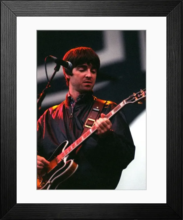 Framed Print : Noel Gallagher of Oasis playing guitar on stage during their concert at Balloch Country