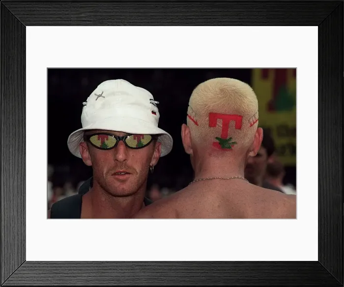 Framed Print : Man with T in the Park logo sunglasses with the back of a mans head with the T in