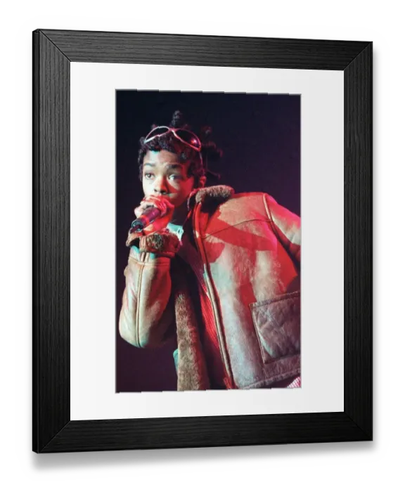 Framed Print : Lauryn Hill 1996 singer with the pop group The Fugees holding microphone in hand up Framed Print : Lauryn Hill 1996 singer with the pop group The Fugees holding microphone in hand up