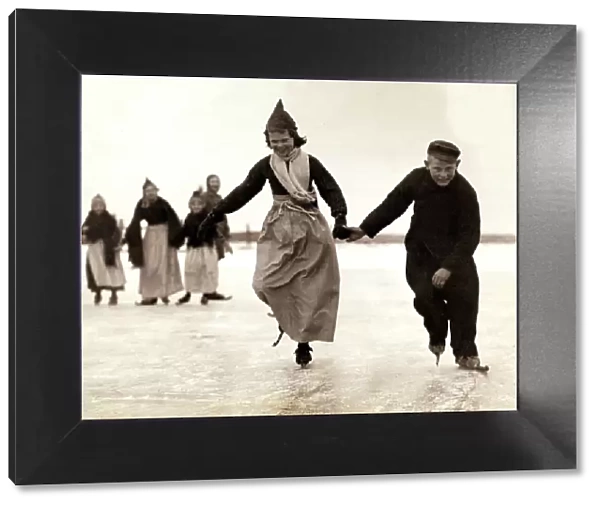Dutch children skating on the frozen inland sea near their home of Volendam, Holland