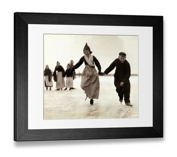 Framed Print : Dutch children skating on the frozen inland sea near their home of Volendam, Holland Framed Print : Dutch children skating on the frozen inland sea near their home of Volendam, Holland