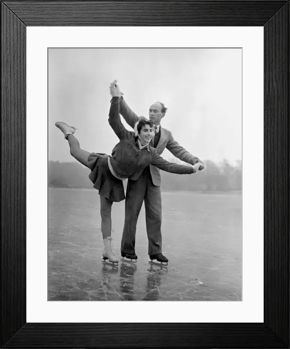 Framed Print : A couple ice skating on a frozen lake in winter January 1954
