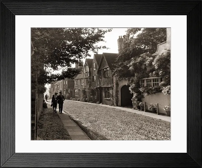 Framed Print : Couple walking down a quiet cobbled road in Rye Sussex Framed Print : Couple walking down a quiet cobbled road in Rye Sussex