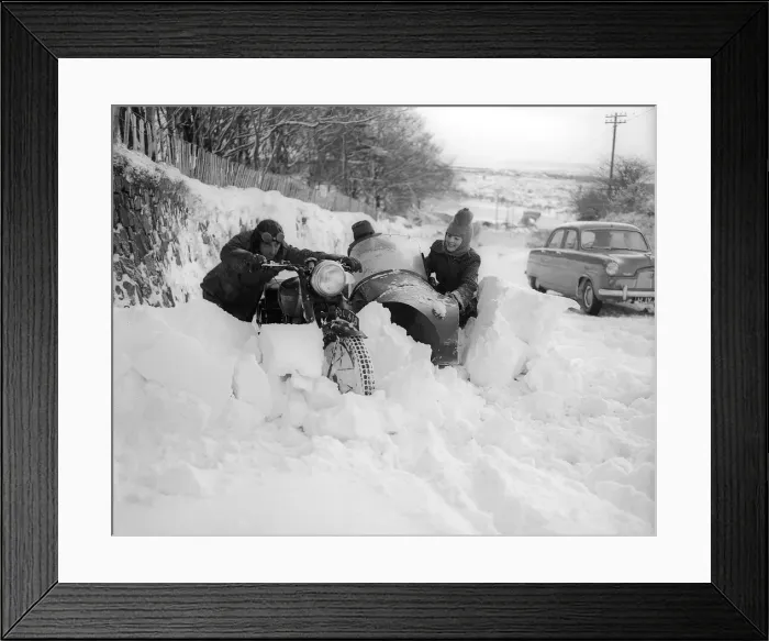 Framed Print : Two motor cyclists try to push through giant snow drifts in Devon but find the roads Framed Print : Two motor cyclists try to push through giant snow drifts in Devon but find the roads