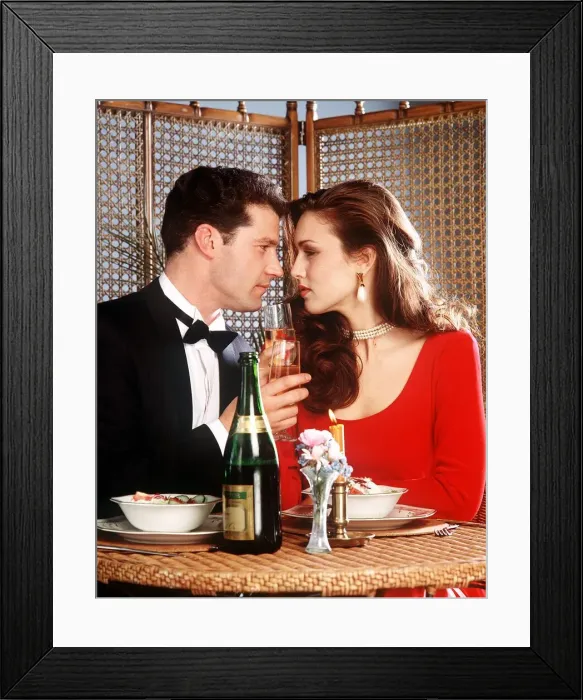 Framed Print : Couple having dinner staring into each others eyes drinking champagne Framed Print : Couple having dinner staring into each others eyes drinking champagne