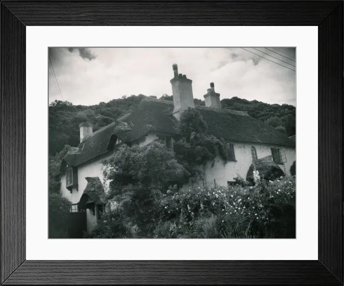 Framed Print : Somerset traditional thatched cottage at Selworthy in Somerset House surrounded by