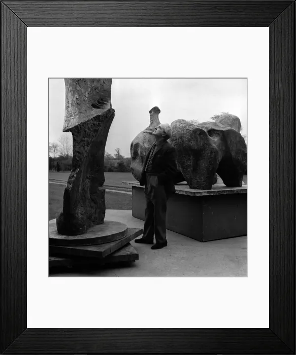 Framed Print : Henry Moore Artist and Sculptor outside his studio casting a critical over two-pieces of