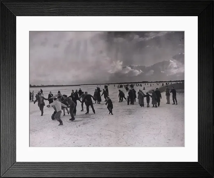 Framed Print : People skating on the frozen Hickling Broad in Norfolk after it iced over Framed Print : People skating on the frozen Hickling Broad in Norfolk after it iced over