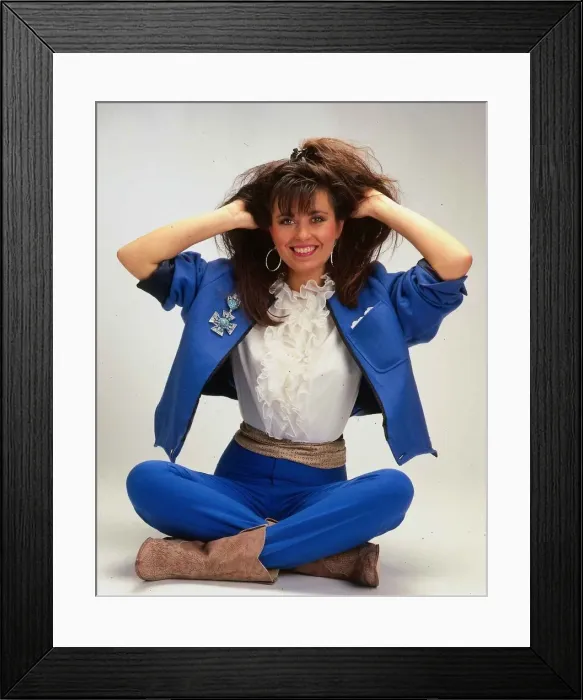 Framed Print : Debbie Greenwood TV presenter sitting on floor wearing blue jacket