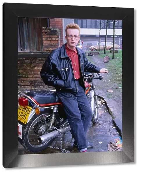 TV presenter Bryan Burnett sitting on motorcycle 1990