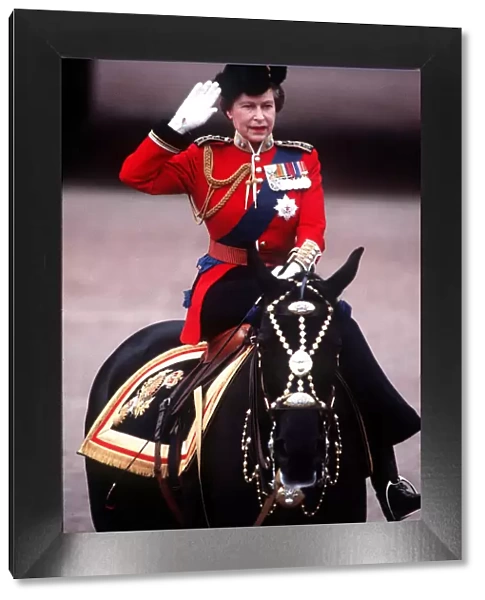 The Queen Trooping The Colour takes salute at Palace gates. June 1984