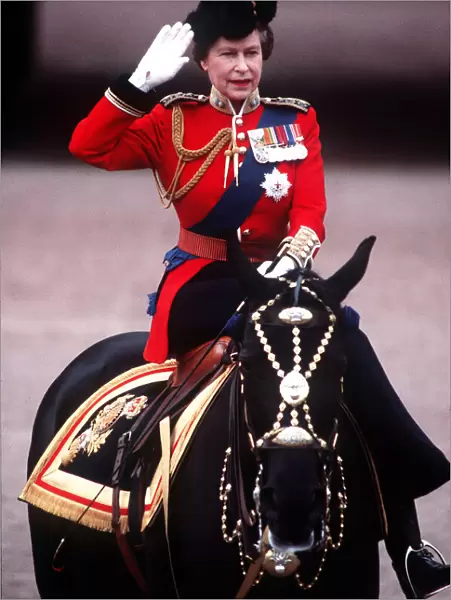 The Queen Trooping The Colour takes salute at Palace gates. June 1984