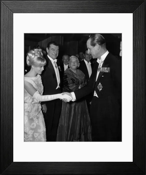 Framed Print : Prince Philip is introduced to Britt Ekland at the Royal Command performance of Move Framed Print : Prince Philip is introduced to Britt Ekland at the Royal Command performance of Move