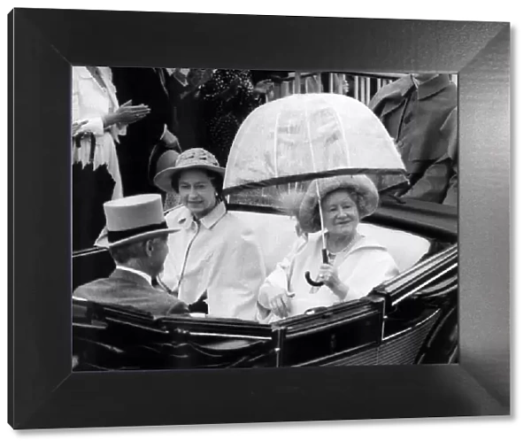 Queen Mother riding down the course with the Queen in an open top carriage in the Ascot