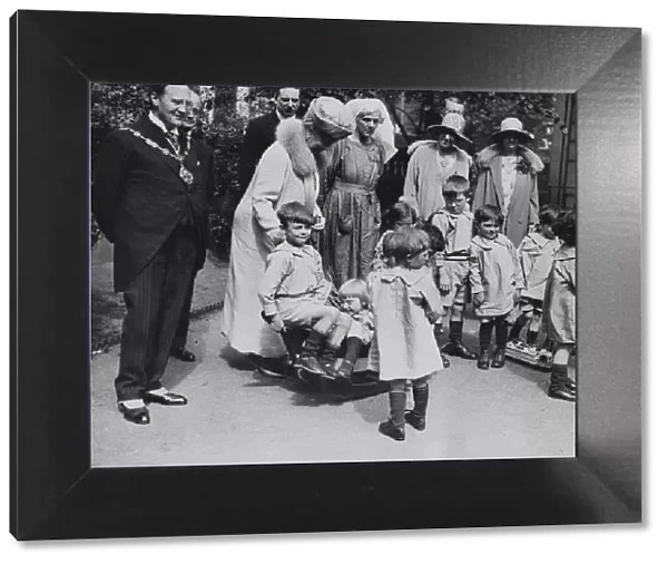 Queen Mary visits Orphanage. Queen Mary and local mayor visit orphans at playtime