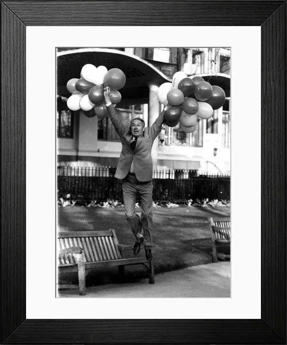 Framed Print : Millionaire airline owner Freddie Laker holding a bunch of balloons after bouncing back Framed Print : Millionaire airline owner Freddie Laker holding a bunch of balloons after bouncing back